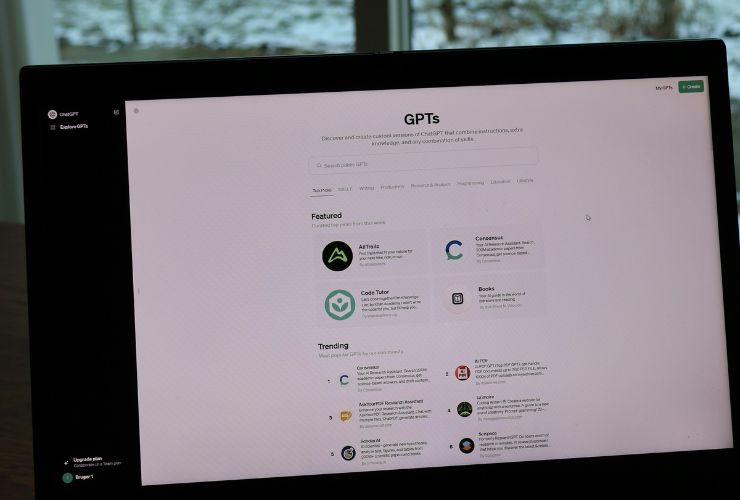 Laptop screen displaying GPT generative AI tools for digital content creation in a home office setting