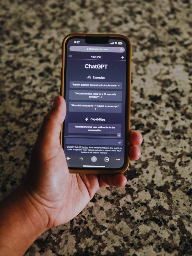 Hand holding a smartphone displaying ChatGPT, illustrating generative AI in daily life.